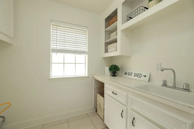 a kitchen with a sink cabinets and window