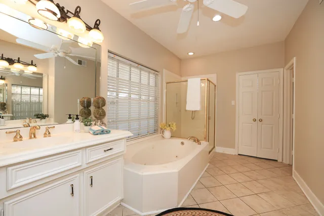 a spacious bathroom with a sink mirror and a bathtub