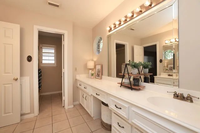 a spacious bathroom with a double vanity sink and a mirror