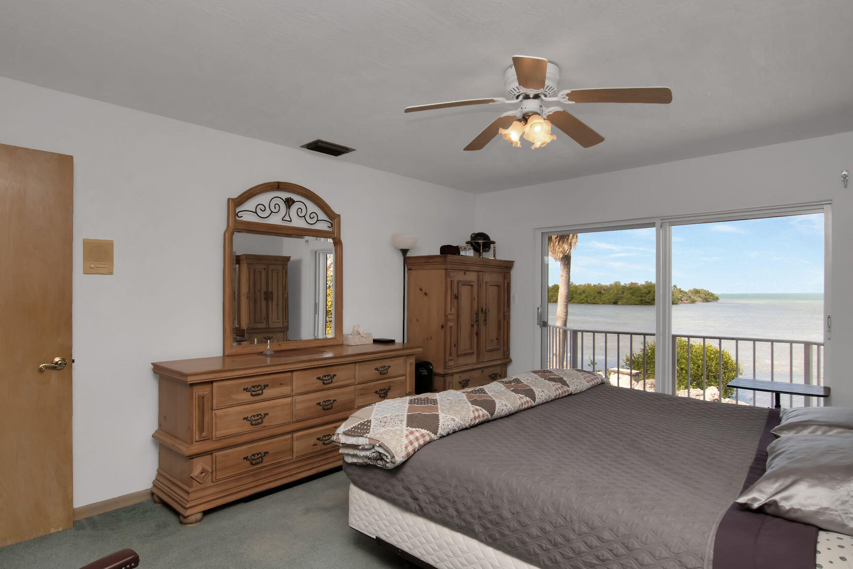 140 Brian Road Marathon, FL 33050 - Photo 5 of 54 a bedroom with a bed a chandelier and large window