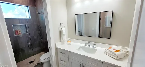 a bedroom with a bed and a lamp