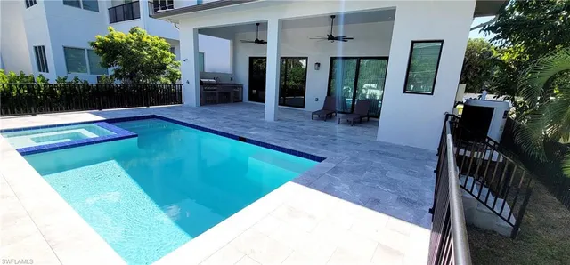 a view of an house with swimming pool and seating space