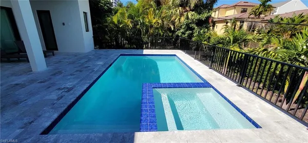 a view of swimming pool with seating area