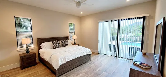 a living room with a fireplace and a floor to ceiling window