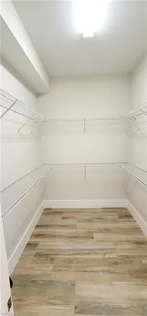 a spacious bathroom with a double vanity sink a mirror and shower