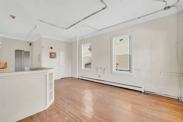 an empty room with windows and closet
