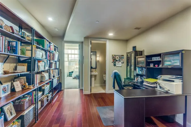 a view of a workspace with furniture bookshelf and a window