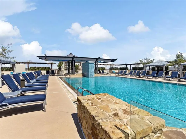 a view of swimming pool with seating area and hardwood floor