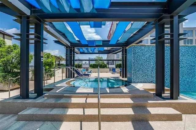 a view of a patio with table and chairs potted plants with floor to ceiling window