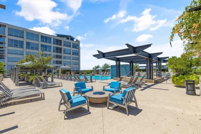 a view of a patio with chairs and plants