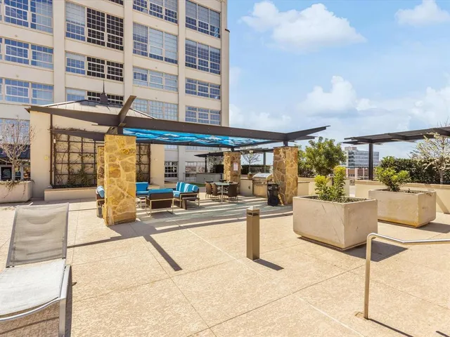 a view of a patio with dining table and chairs with wooden floor