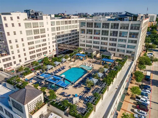 a view of a fountain with a bench in front of building
