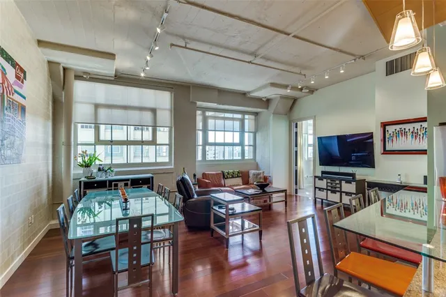 a living room with furniture a window and a flat screen tv