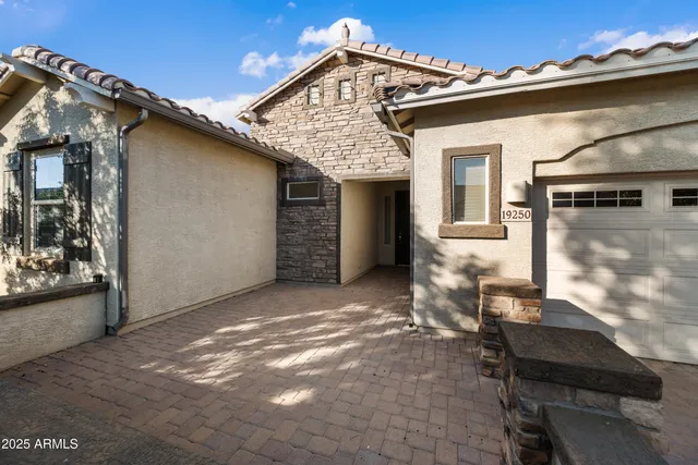 a view of a house with backyard and sitting area