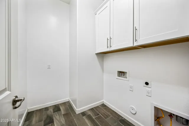 a view of storage and utility room with a wooden floor