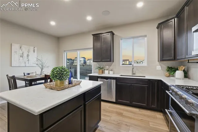 a kitchen with a stove a sink and a refrigerator