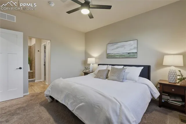 a bedroom with a bed and lamp