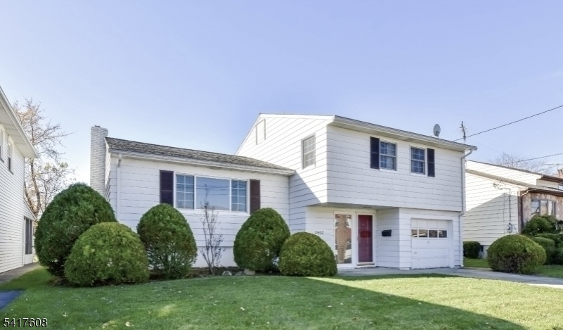 a view of a house with a yard and plants