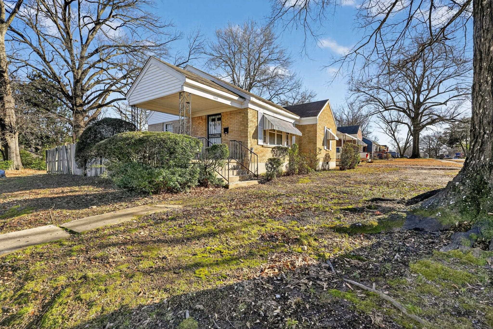 View of property exterior with brick siding