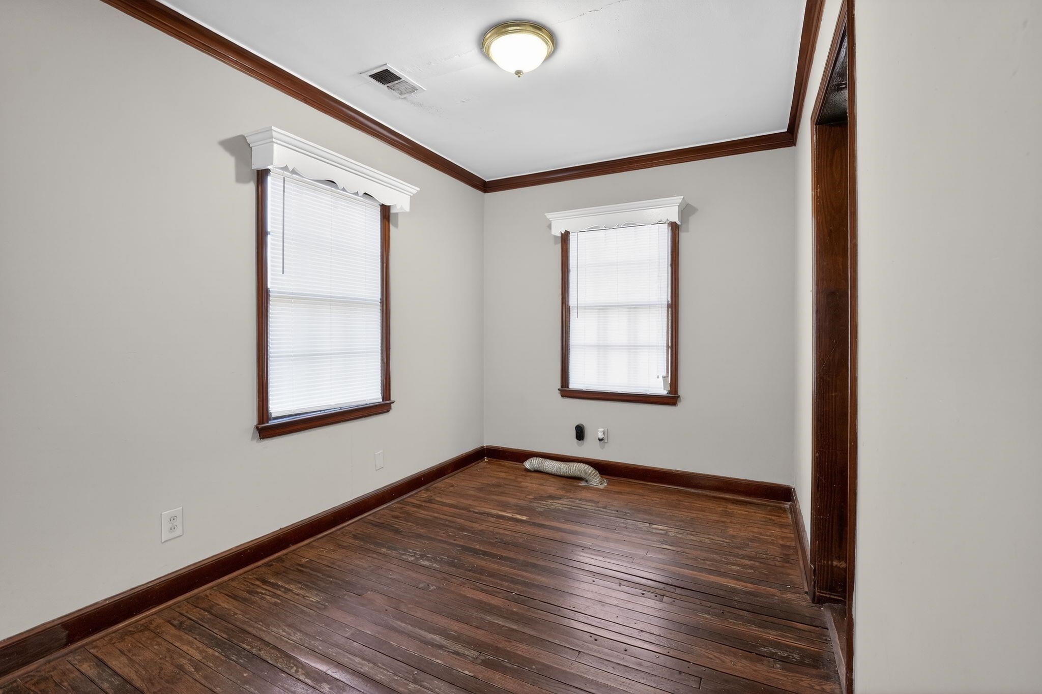1068 Mt Vernon Road Memphis, TN 38111 - Photo 12 of 31 Spare room with dark wood-style flooring and crown molding