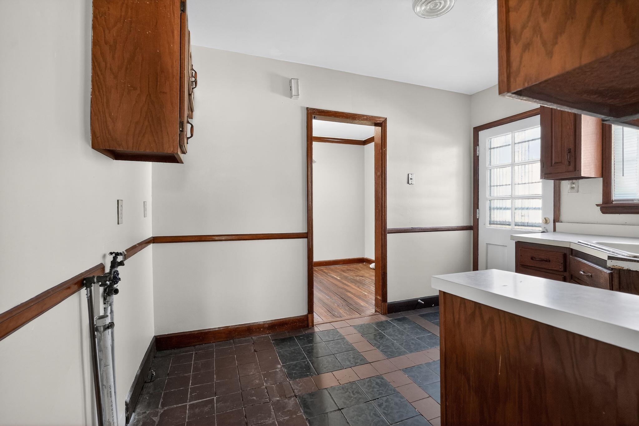 1068 Mt Vernon Road Memphis, TN 38111 - Photo 15 of 31 Kitchen featuring light countertops and brown cabinetry