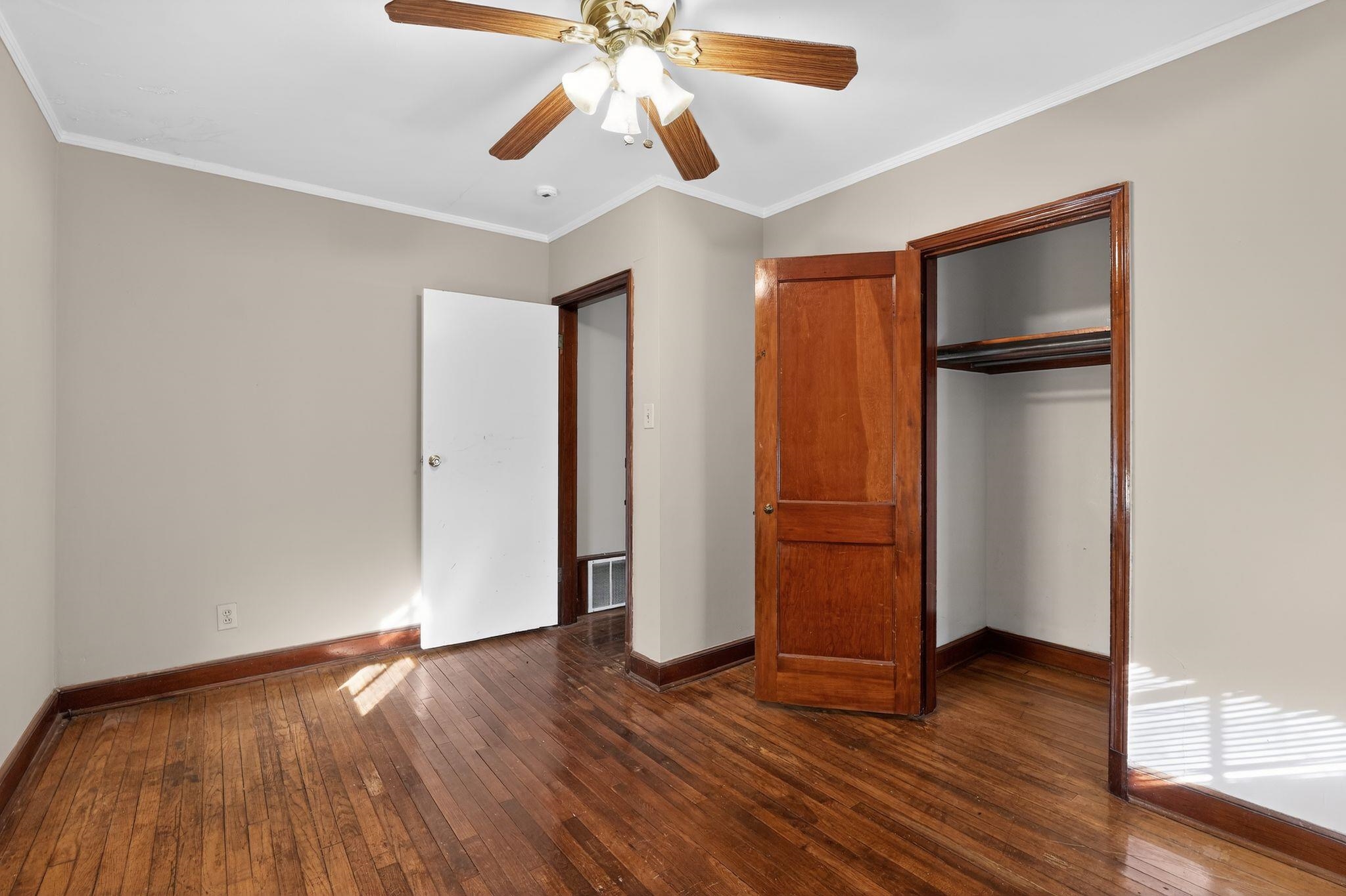 1068 Mt Vernon Road Memphis, TN 38111 - Photo 17 of 31 Unfurnished bedroom with ornamental molding, dark wood-style floors, a closet, and ceiling fan