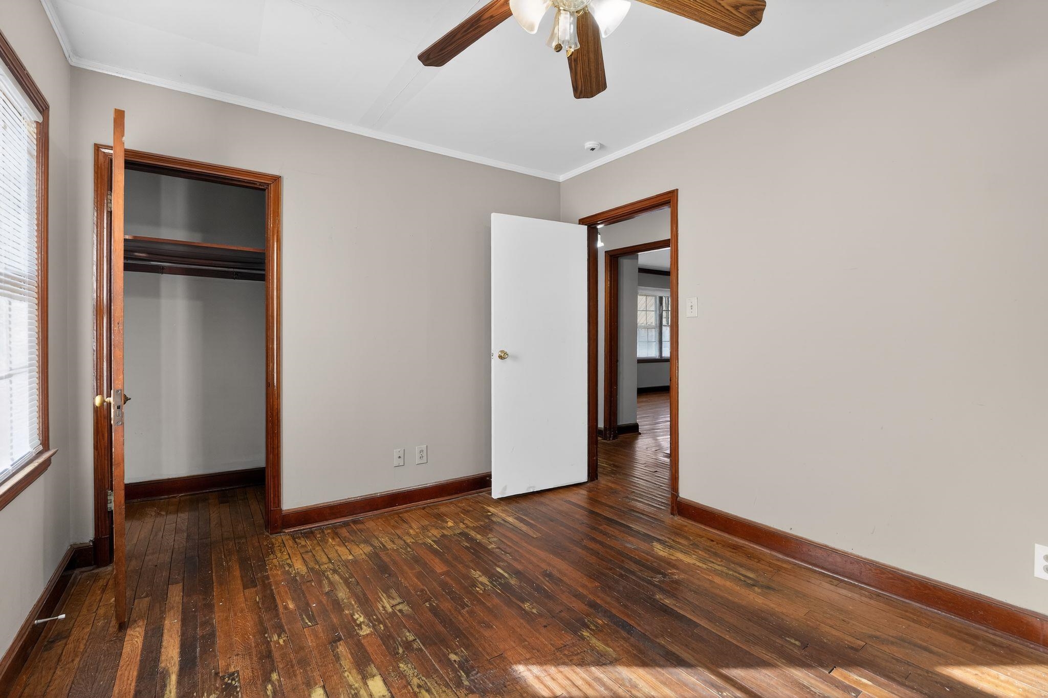 1068 Mt Vernon Road Memphis, TN 38111 - Photo 18 of 31 Unfurnished bedroom featuring dark wood-type flooring, ceiling fan, ornamental molding, and a closet