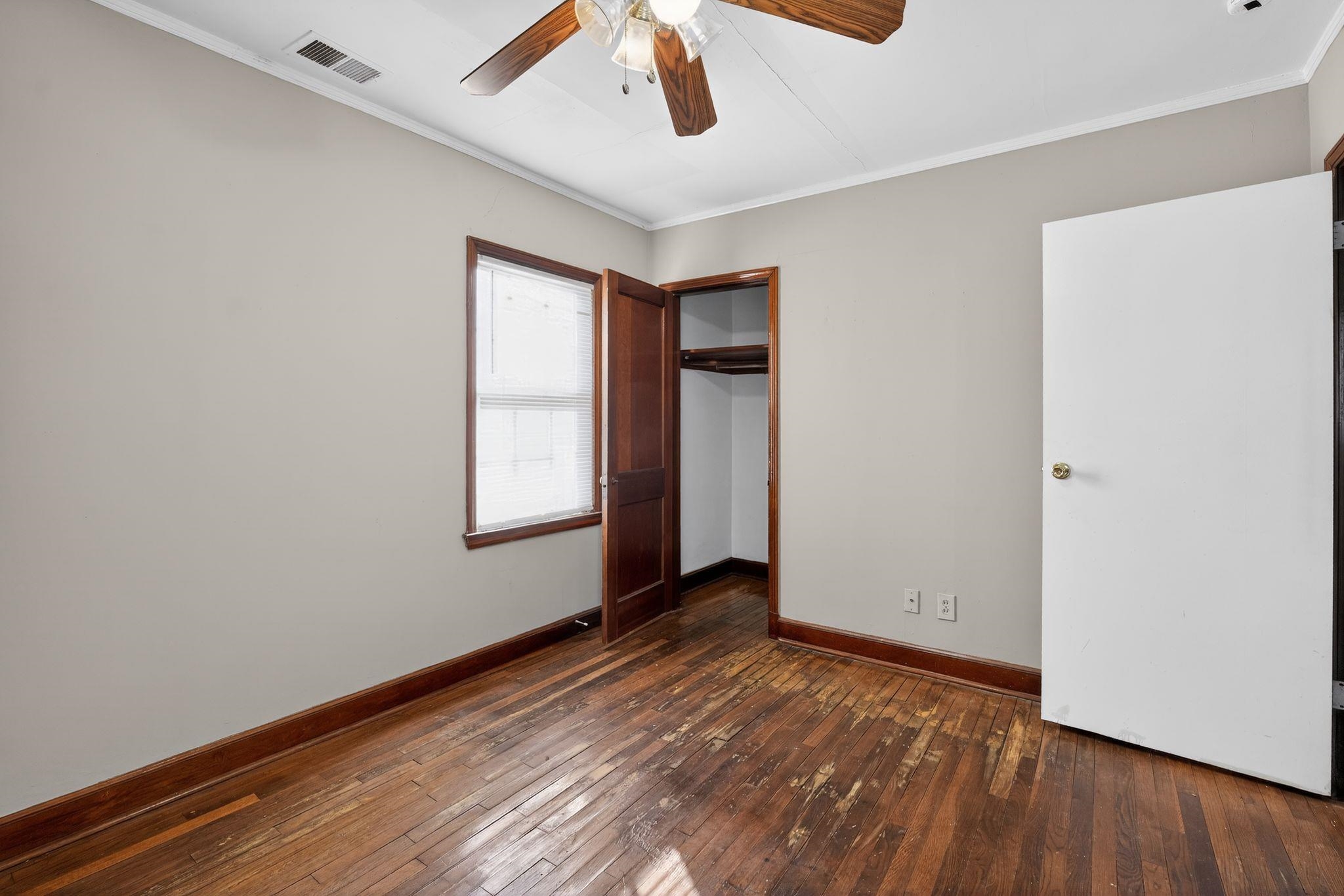 1068 Mt Vernon Road Memphis, TN 38111 - Photo 20 of 31 Unfurnished bedroom with dark wood-style flooring, ornamental molding, a closet, and ceiling fan