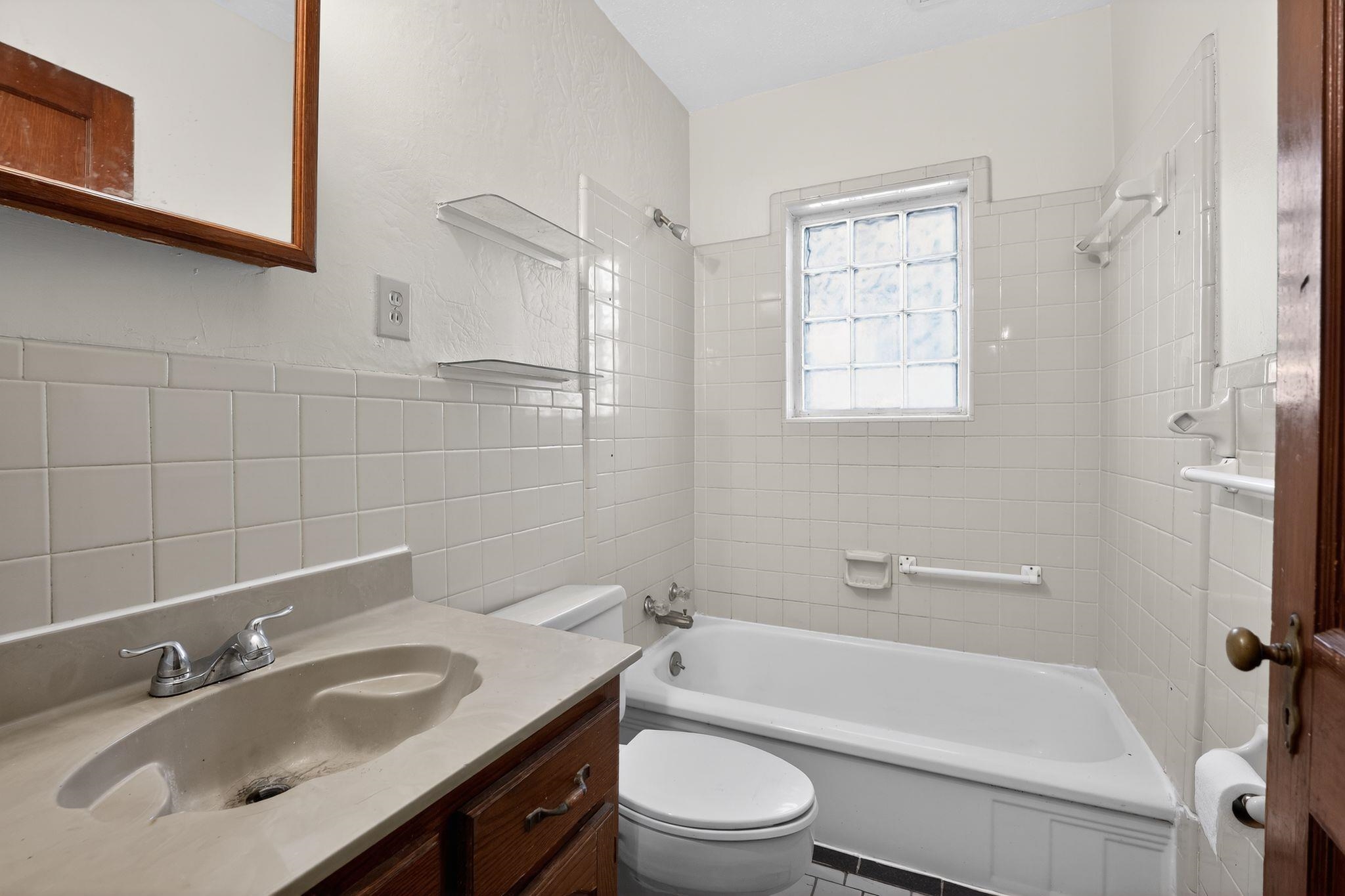 1068 Mt Vernon Road Memphis, TN 38111 - Photo 23 of 31 Bathroom with vanity, shower combination, and tile walls