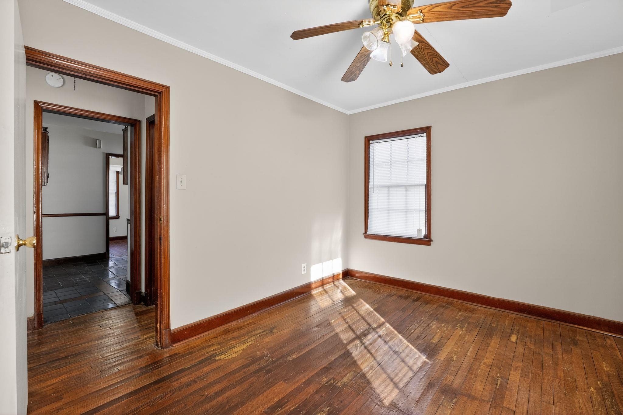 1068 Mt Vernon Road Memphis, TN 38111 - Photo 7 of 31 Unfurnished room with dark wood-type flooring, ornamental molding, and a ceiling fan