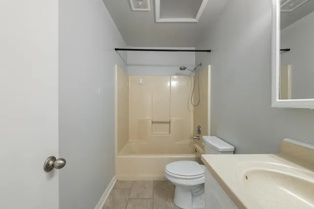 a bathroom with a toilet a sink and shower