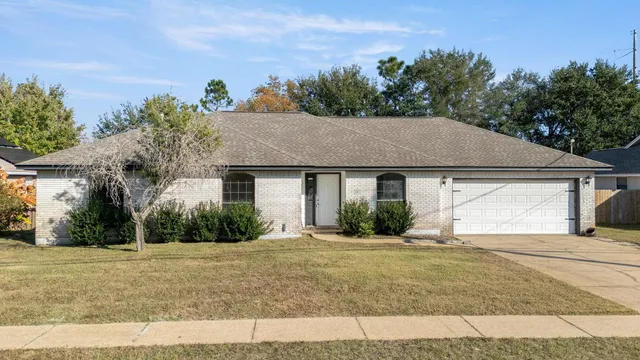 a aerial view of a house with a yard