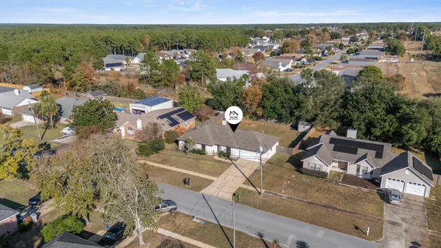 an aerial view of a house with a yard