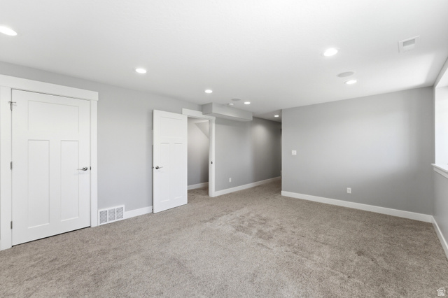 1614 Aspen Loop Provo, UT 84606 - Photo 30 of 47 Spacious room featuring neutral gray walls, light-colored carpeting, white trim, and recessed lighting
