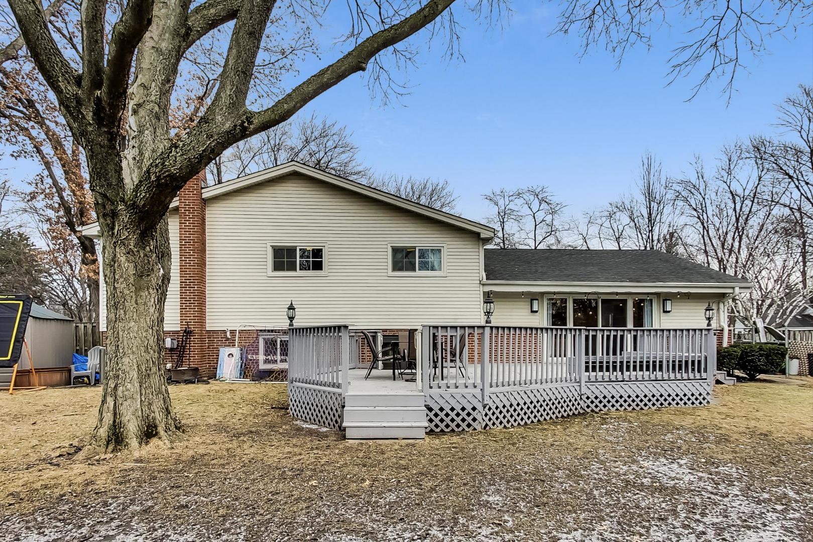 1920 Barberry Road Northbrook, IL 60062 - Photo 20 of 24 a view of a house with a wooden deck and a floor to ceiling window