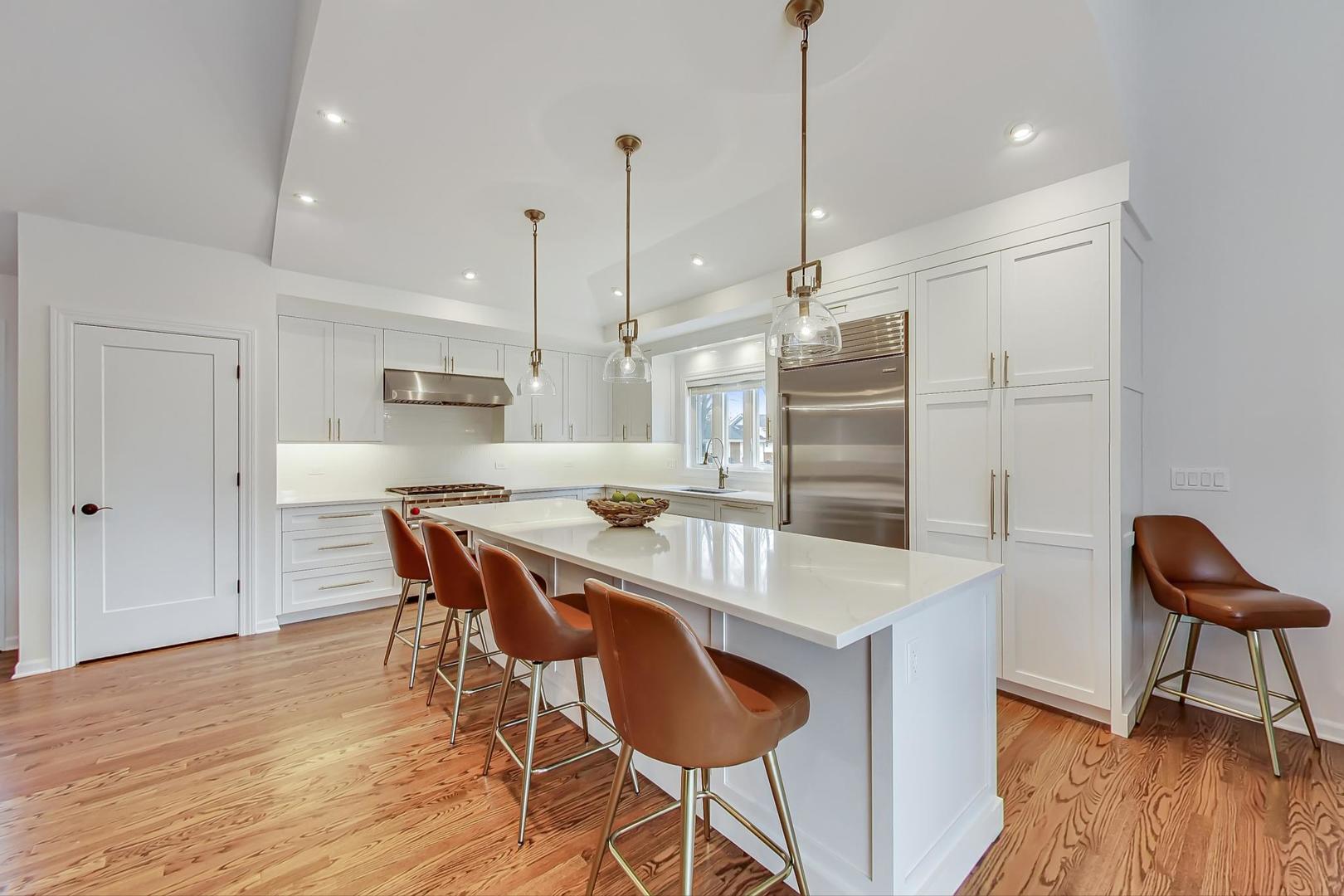 1920 Barberry Road Northbrook, IL 60062 - Photo 2 of 24 a kitchen with granite countertop a table chairs a sink dishwasher refrigerator and cabinets
