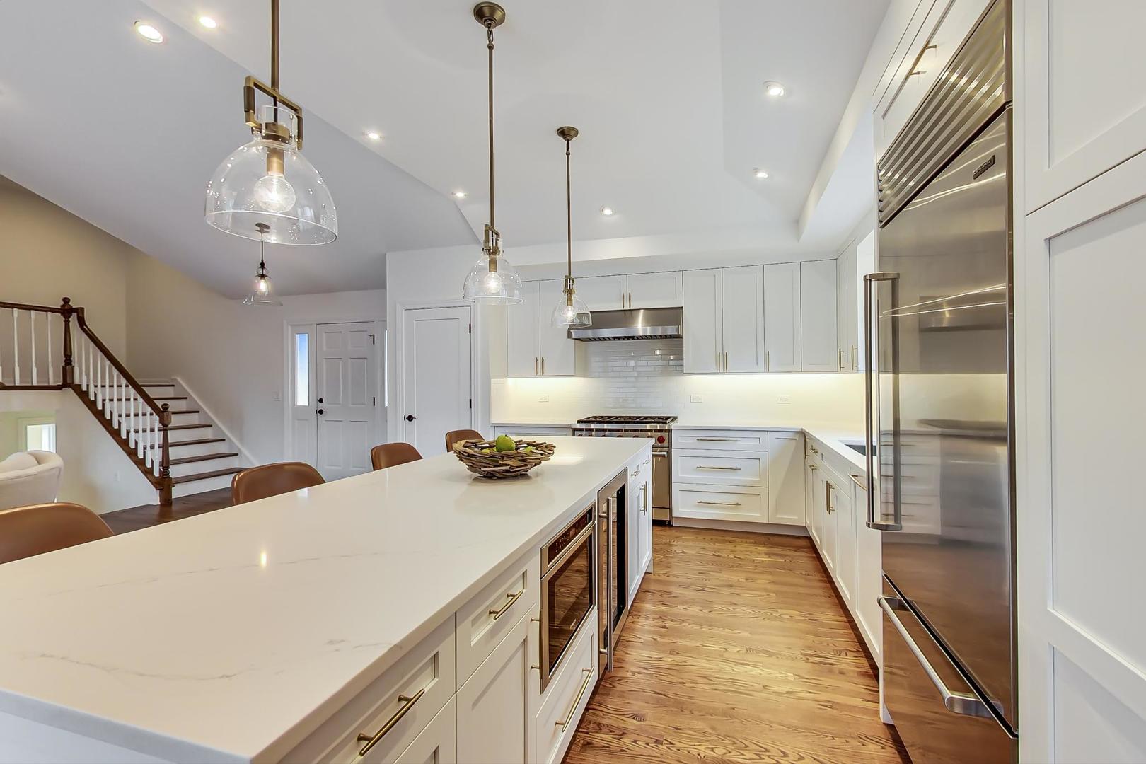 1920 Barberry Road Northbrook, IL 60062 - Photo 5 of 24 a large kitchen with kitchen island a large counter space a sink appliances and cabinets