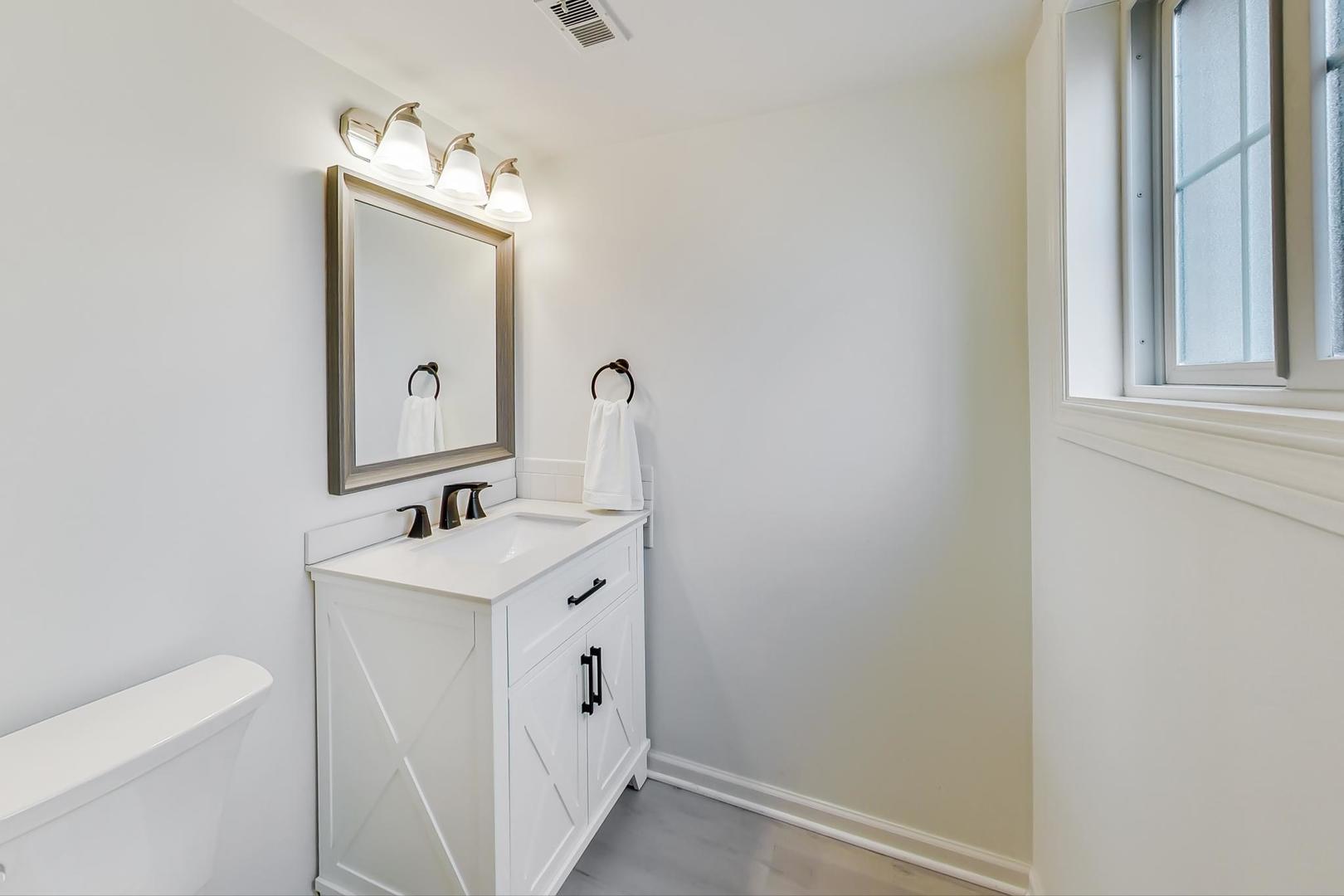 1920 Barberry Road Northbrook, IL 60062 - Photo 10 of 24 a bathroom with a toilet sink and mirror