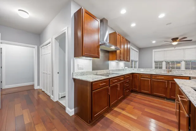 a kitchen with stainless steel appliances granite countertop a stove and a sink