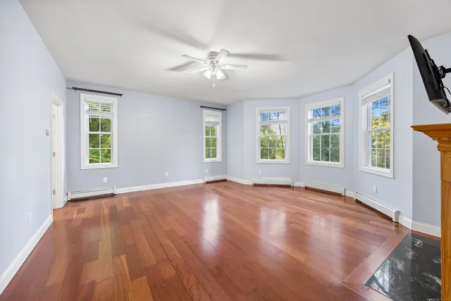 wooden floor in an empty room with a window
