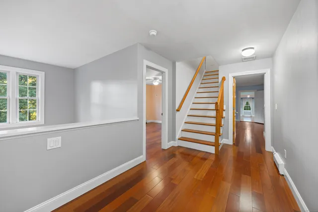 wooden floor in an empty room with a window