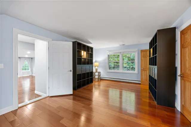 wooden floor in an empty room with a window