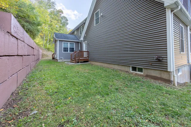 a view of a house with backyard and sitting area