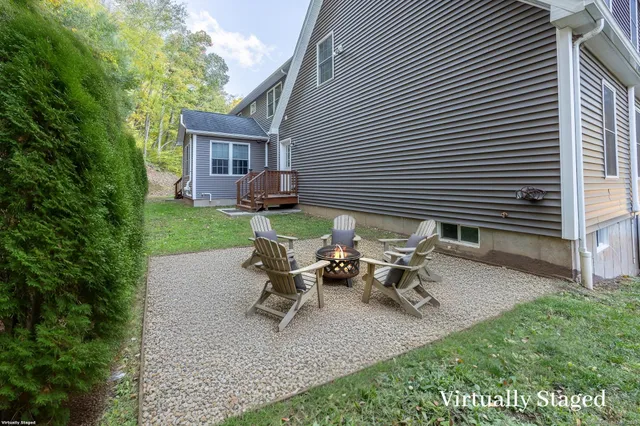 a backyard of a house with table and chairs