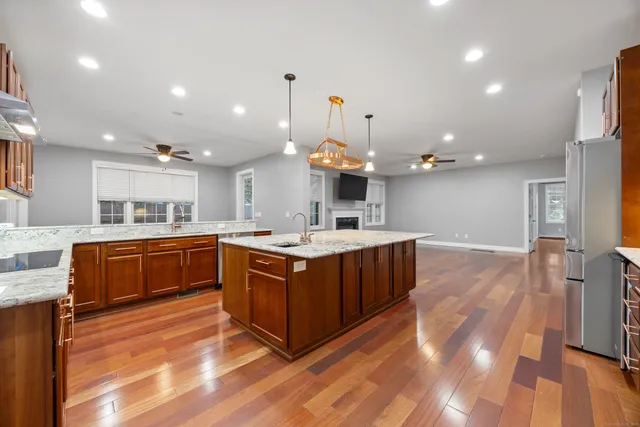 a kitchen with kitchen island a sink and a stove