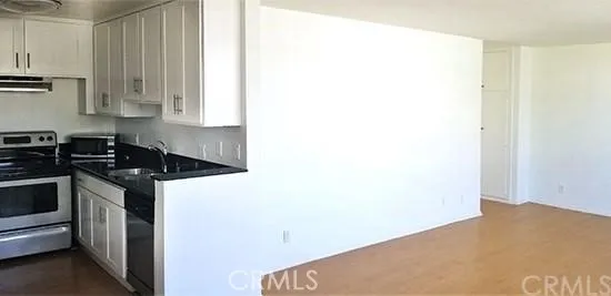 a kitchen with a stove and a refrigerator