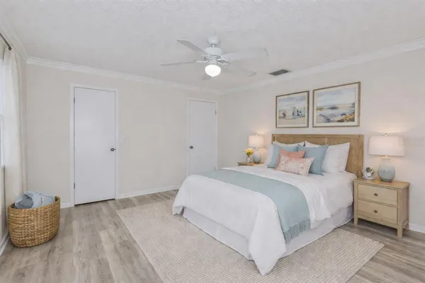 a bedroom with a bed and a painting on the wall