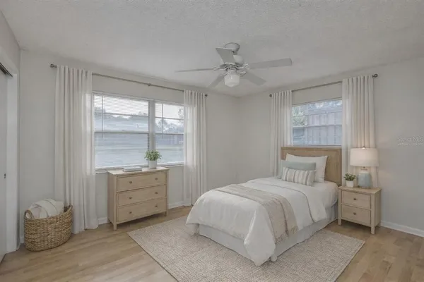 a bedroom with a large bed and a chandelier
