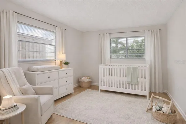 a room with a baby crib and a dresser