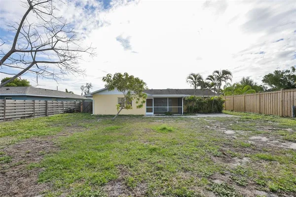 a view of a backyard with large trees